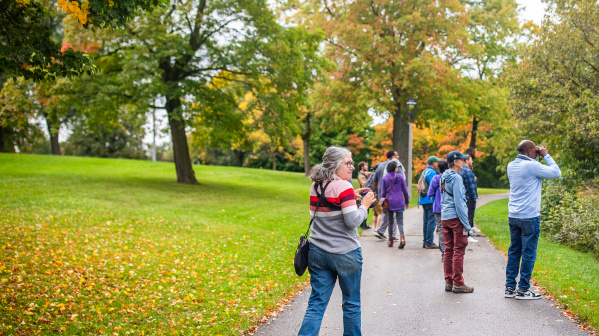 a woman with binoculars birding in a park