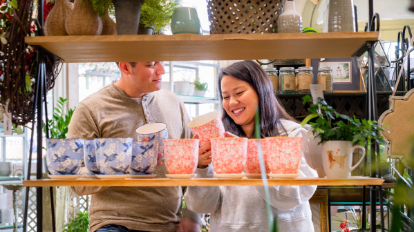 couple looking at colorful plant pots