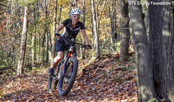 Woman mountain biking in the fall