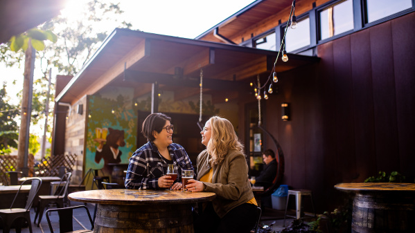 couple enjoying a beer at a table on patio