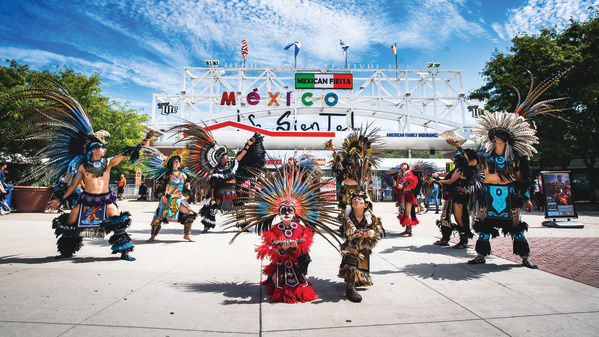 traditional Mexican dance in front of Mexican Fiesta festival grounds main gate