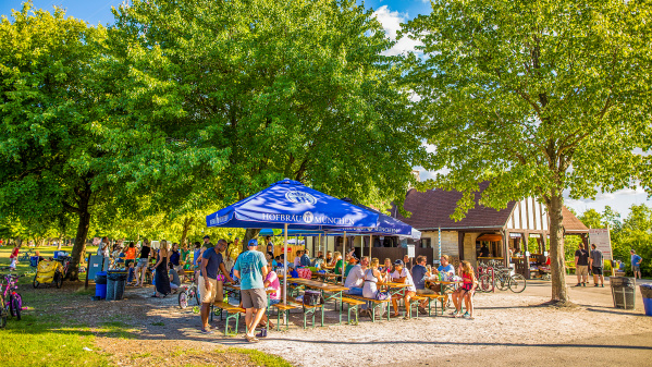 picnic tables filled with people in park