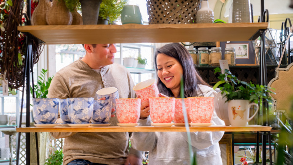 couple looking at colorful plant pots