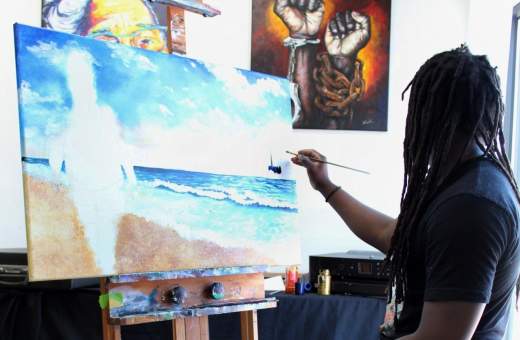 artist painting a canvas in a gallery