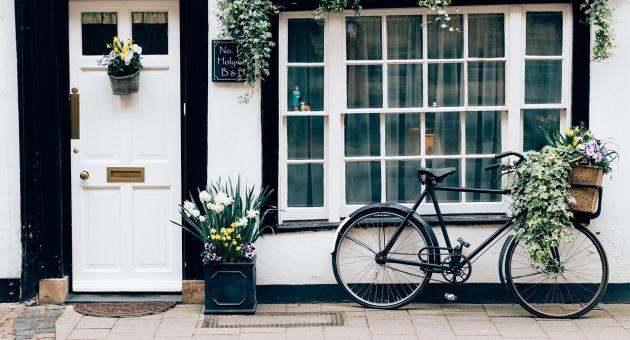 a B&B in Horncastle with white walls and a bike with with planter at the door