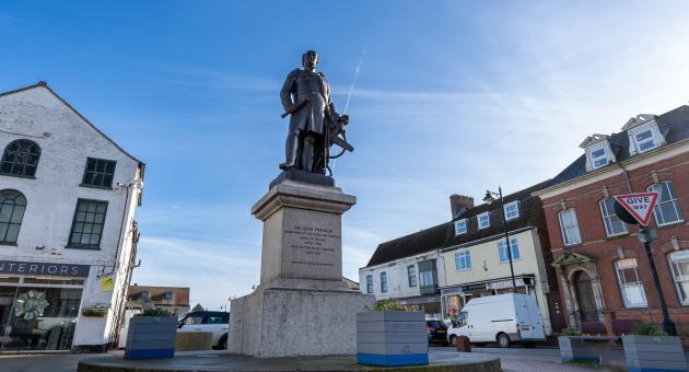 a statue of Sir John Franklin in Spilsby town under blue skies