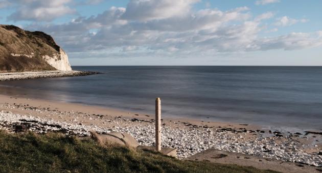 Active beacon photopost on the pebble beaches of East Yorkshire.