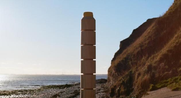 An active beacon post overlooking the rugged coastline an sea.