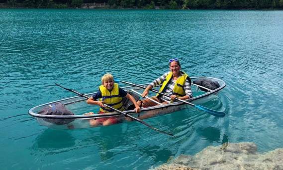 a family on a glass boat at green lakes