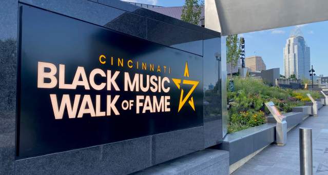 A black marble sign that says Cincinnati Black Music Walk of Fame
