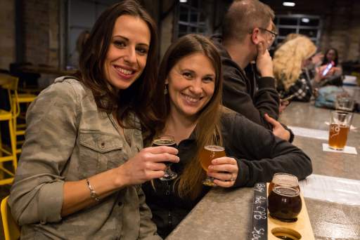 Two friends enjoying a night out at a local brewery in Greater Akron.