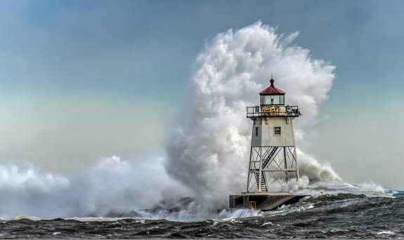 Storm Season - wave breaking over lighthouse - by David Johnson