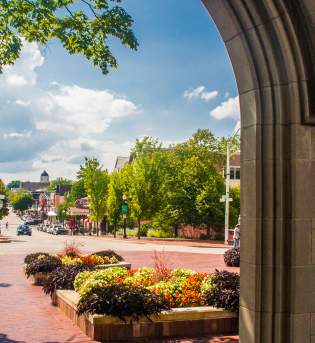 Three men walking toward Sample Gates from Kirkwood