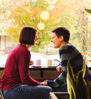 People Sitting With Coffee In Shop Window