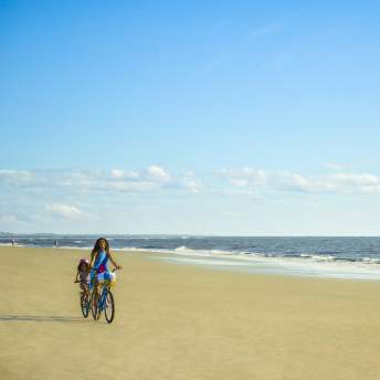 Family biking on East Beach