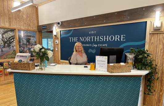 Visitor Services representative Sheila Nolinske covers the reception desk in the Visit The Northshore Visitor Center, May 2025.