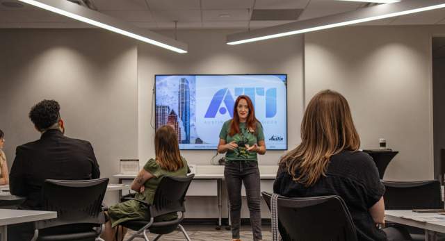 Teacher stands in front of class during Austin Tourism Insider training course