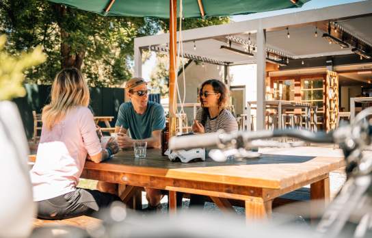 Group of people relaxing at a table at a pub