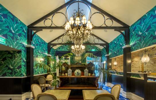 Hulbert House lounge with palm tree decor