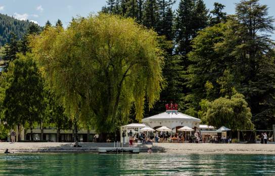 View from the lake looking back at a white cafe shaped like a crown - the Bathhouse Restaurant, a