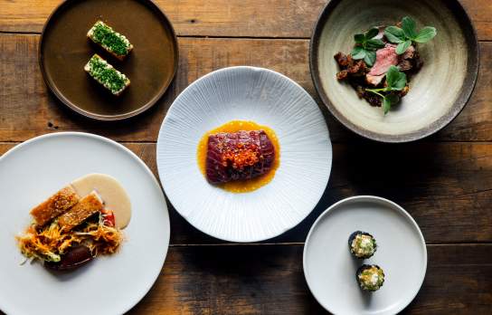 Photo of lots of plates with colourul food