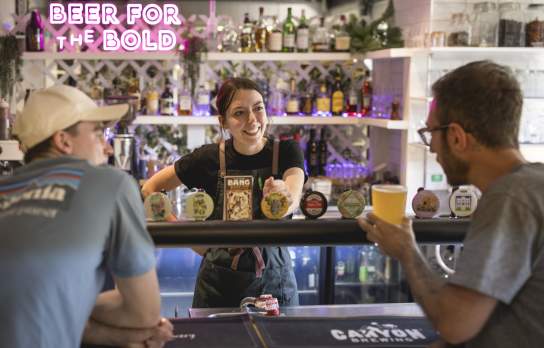 People ordering beer at a bar