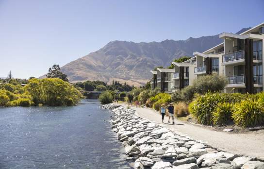 Couple walking in Kelvin Heights with the Remarkables mountain in the background