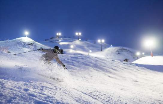 Woman skiing at night