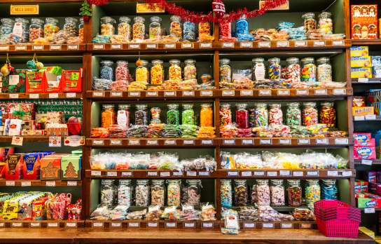 Wide shot of shelves lined with colourful sweets