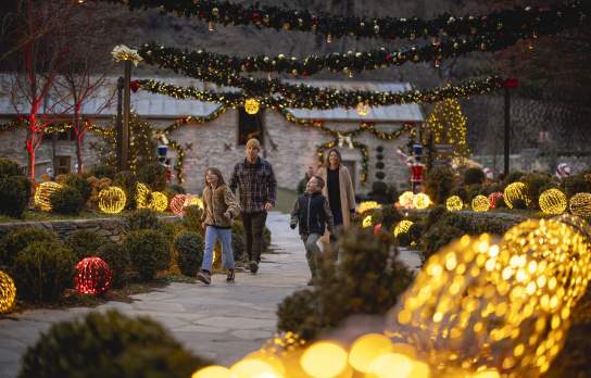 A family walking in among light up decortions