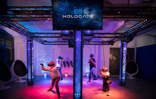 People in a colourful virtual reality area