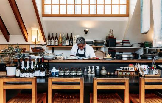 Chef working behind food station at Kappa Japanese restaurant surrounded by quirky Japanese serve wear