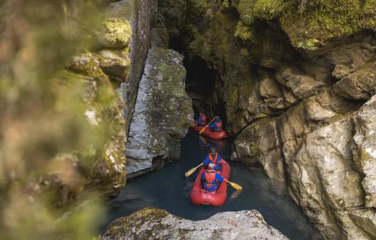 Group of people on inflatable Funyaks going into a chasm