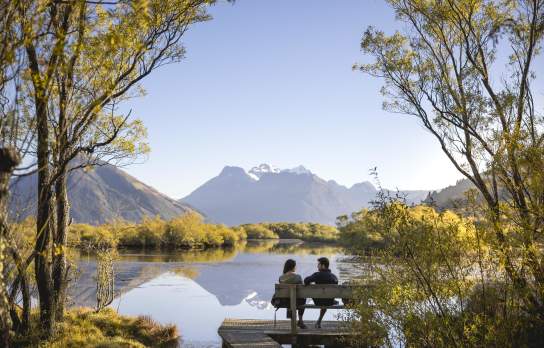 People sitting at on a scenic bench at Glenorchy Lagoon Walkway