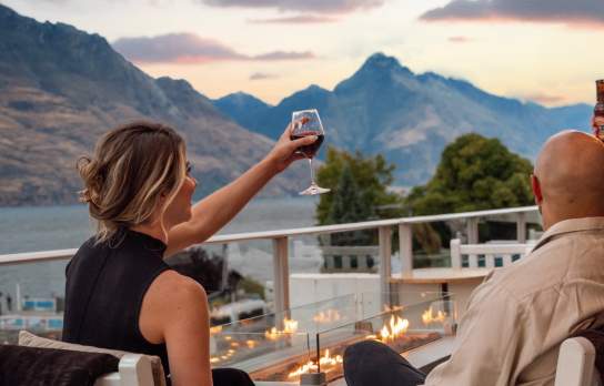 A couple enjoying the Queenstown sunset at The Balcony, Crowne Plaza