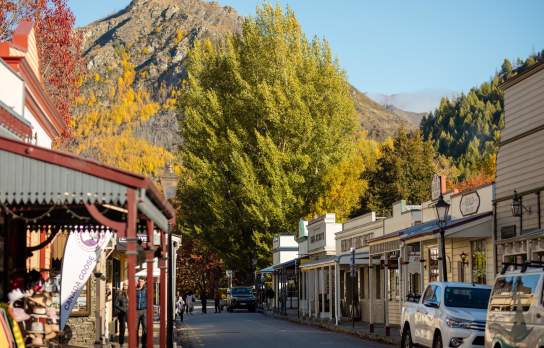 Street lined with old buildings and boutique shops in Arrowtown