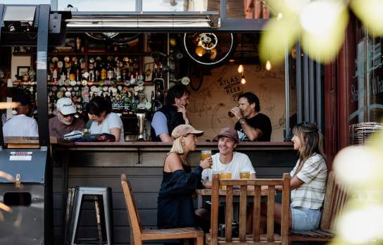 Friends enjoying a pint of beer at Atlas Beer Cafe in Queenstown