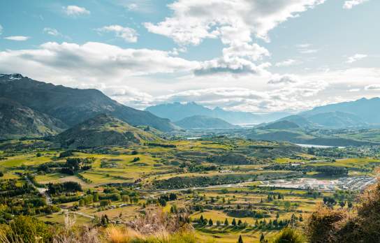 View from Tobin's Track of green valley with mountains in the distance