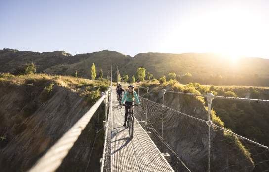 Biking across the Edgar Bridge on the Arrow River Bridges Trail