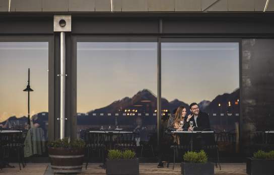 Two people dining out front of The Grille by Eichardt's Restaurant