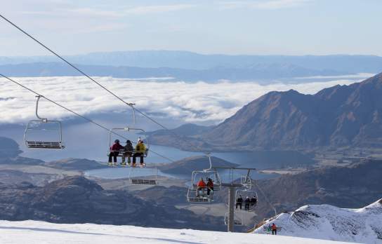 People riding the chairlift at Treble Cone Ski Field, Wānaka