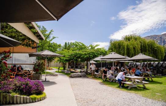 Shot of Kinross Winery & Bistro outdoor courtyard on a sunny day with people dining
