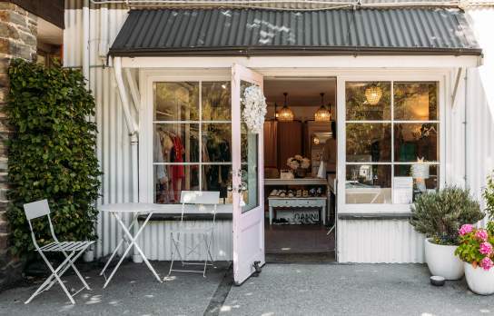 Outside view of a a white, cottage-style looking boutique shop