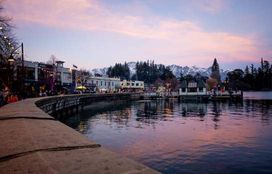 Queenstown waterfront in winter at sunset with the Remarkables mountain range covered in snow