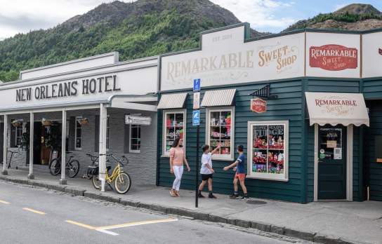 Mother and children walking past the Remarkable Sweet Shop store in Arrowtown