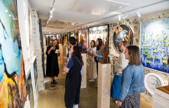 Group looking at art in a colourful art gallery