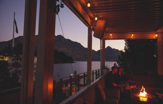 People enjoying a drink at sundeck roof top bar