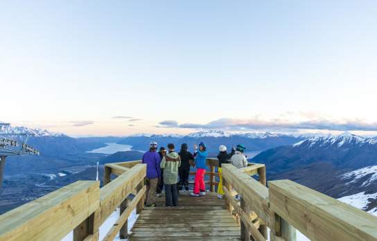 Group of people sightseeing at viewpoint atop of a mountain