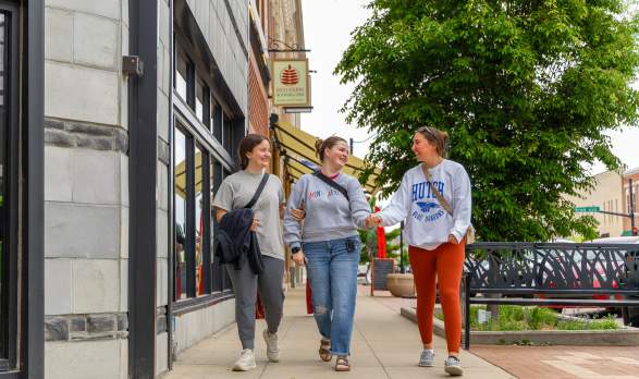 A group of girls walking in downtown Salina Kansas, laughing and smiling