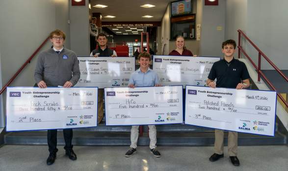 Group of people with checks from Project Open in Salina, Kansas
